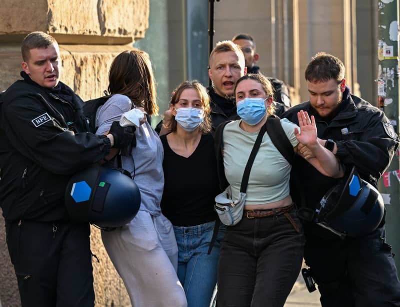 The pro-Palestinian occupiers of the Institute of Social Sciences at Berlin's Humboldt University (HU) leave the building with a police escort. Activists have occupied the university in support of the Palestinians and in protest against Israel. Soeren Stache/dpa