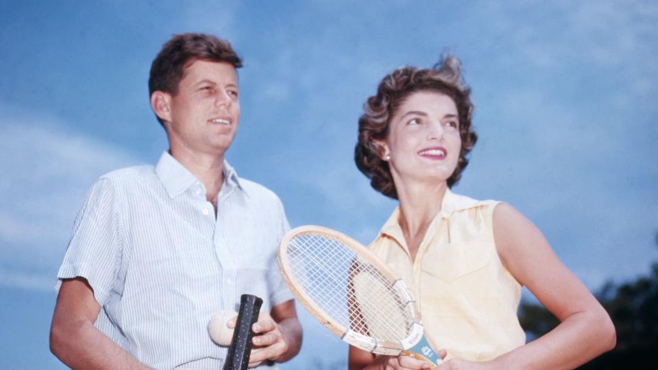 John Kennedy and his fiancee Jacqueline Bouvier play tennis.