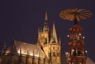 A giant Christmas pyramid spins at the illuminated Christmas market near the cathedral in Erfurt, Germany.