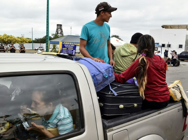 Venezuelan migrants ride on the back of a pickup truck as they leave the binational border attention centre (CEBAF) in Huaquillas, Southern Ecuador in the border with Peru on August 24, 2018. Ecuador opened a "humanitarian corridor" to allow masses of migrants escaping Venezuela's free-falling economy to stream towards the Peruvian border Friday, hours before Lima puts new restrictions on entry into effect