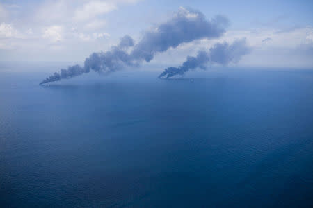 Oil is burned off the surface of the water near the source of the Deepwater Horizon oil spill, July 13, 2010. REUTERS/Lee Celano