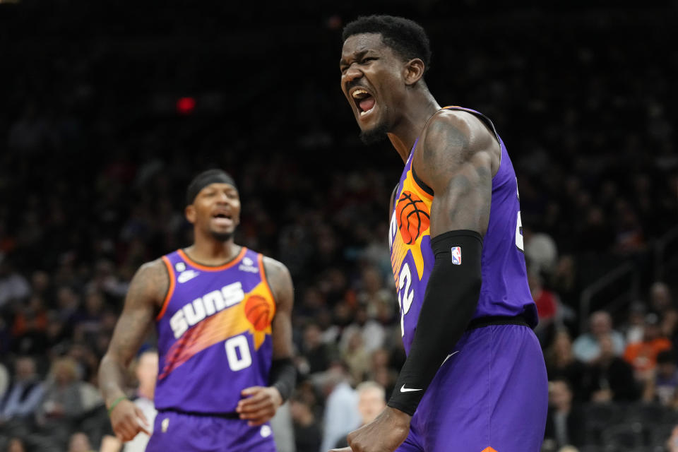 Phoenix Suns center Deandre Ayton, right, celebrates his blocked shot against the Chicago Bulls as Suns forward Torrey Craig (0) joins in on the shouting during the second half of an NBA basketball game in Phoenix, Wednesday, Nov. 30, 2022. The Suns won 132-113. (AP Photo/Ross D. Franklin)