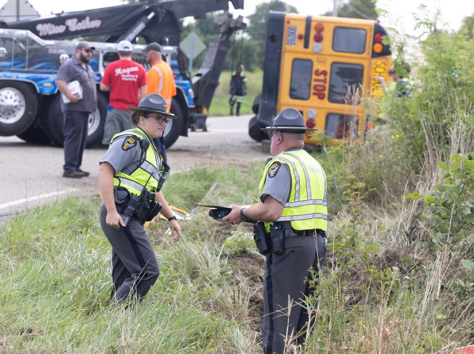 Ohio State Highway Patrol troopers work the scene of a Marlington Local school bus accident Monday afternoon in Marlboro Township. The driver and some students received minor injuries, police said.