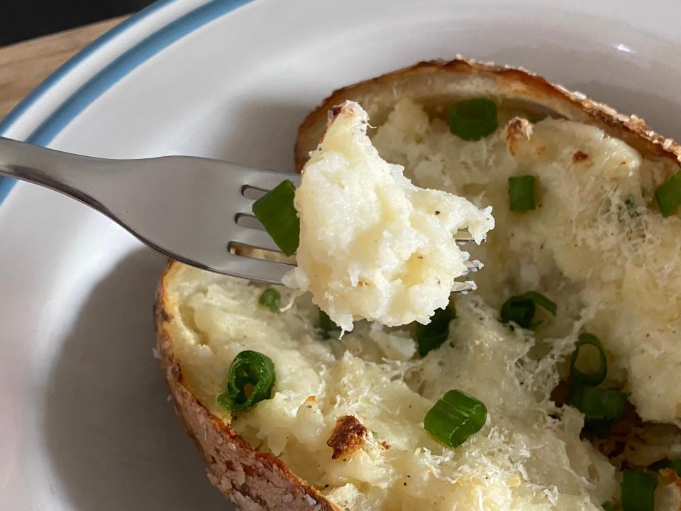 fork picking up some potato from a twice baked potato