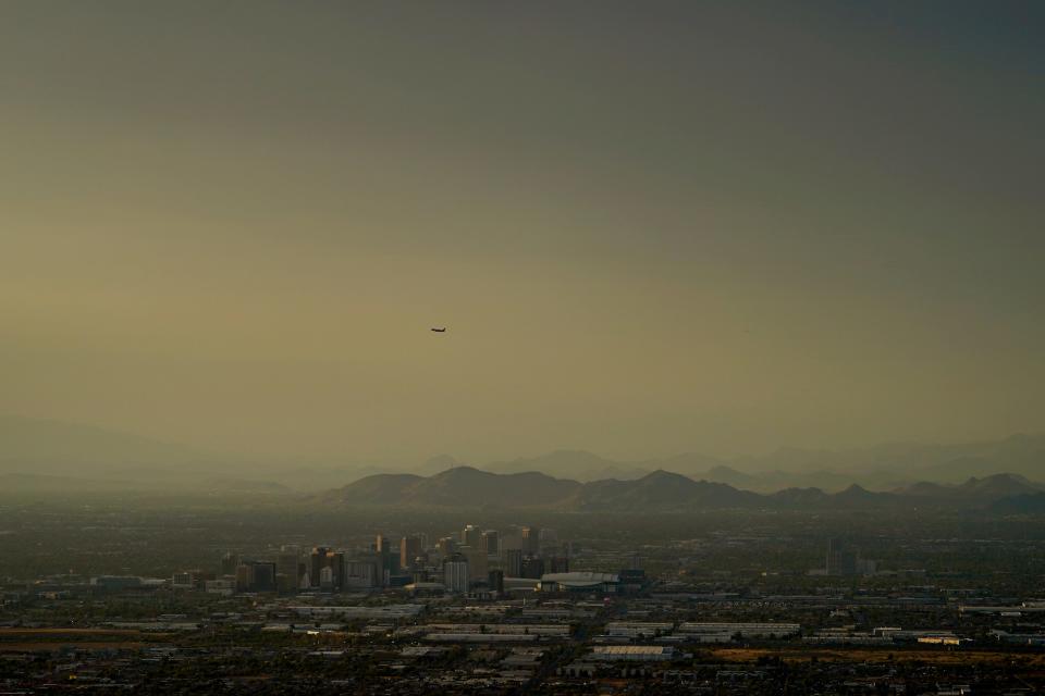 Clouds surround downtown Phoenix at sunset, Sunday, July 30, 2023. Phoenix hit its 31st consecutive day of at least 110 degrees Fahrenheit, (43.3 Celsius).