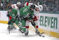 Dallas Stars right wing Alexander Radulov (47) and Carolina Hurricanes defenseman Brendan Smith (7) battle for the puck in the first period of an NHL hockey game Tuesday, Nov. 30, 2021, in Dallas. (AP Photo/Richard W. Rodriguez)