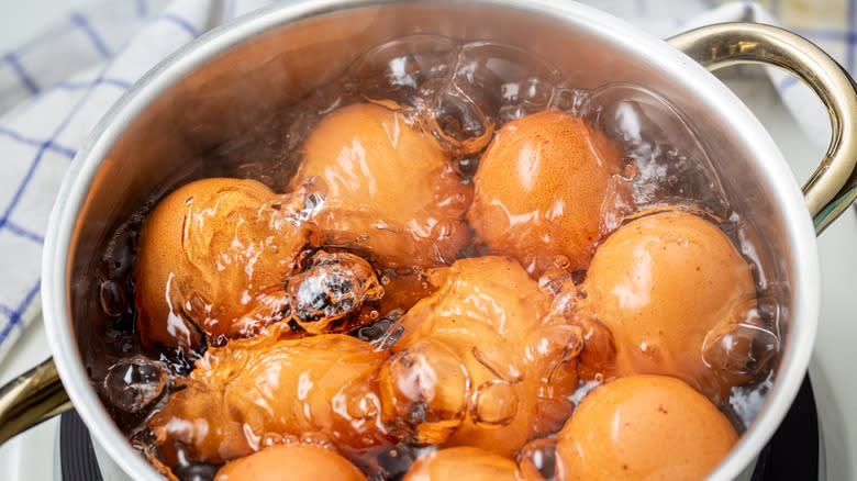 Eggs boiling in pot of water