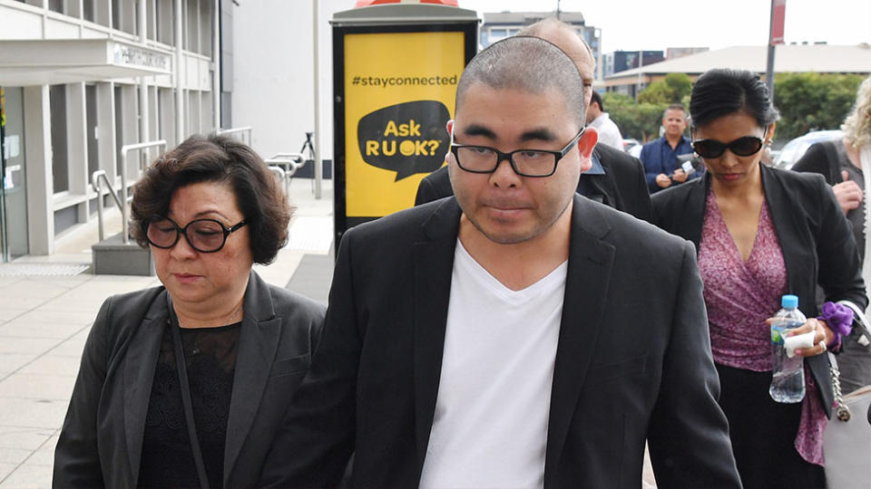 Bronko Hoang (centre), the husband of Katherine Hoang, leaves with family and supporters at the Penrith District Court. Source: AAP