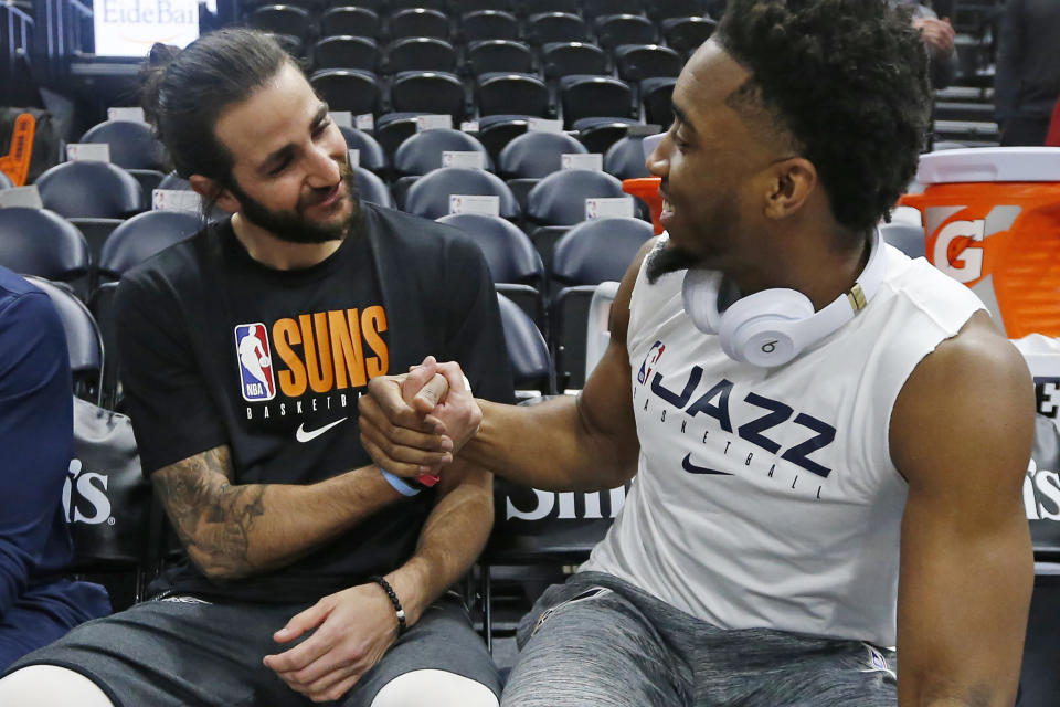 FILE - Phoenix Suns guard Ricky Rubio, left, and Utah Jazz guard Donovan Mitchell talk before an NBA basketball game Monday, Feb. 24, 2020, in Salt Lake City. While Ricky Rubio's retirement from the NBA caught many around the league off guard, Donovan Mitchell sensed it was coming. Mitchell spent two seasons with Rubio in Utah and one in Cleveland. (AP Photo/Rick Bowmer, File)