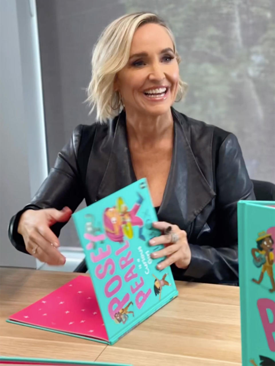 Fifi Box signing a copy of her book