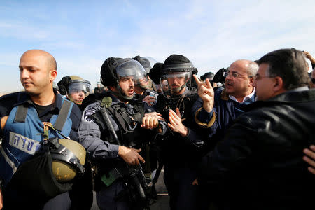 Arab Israeli lawmaker from the Joint Arab List, Ahmed Tibi, (2nd R) is seen during clashes between Arab Israelis and Israeli riot policemen in Umm Al-Hiran, a Bedouin village in Israel's southern Negev Desert January 18, 2017. REUTERS/Ammar Awad