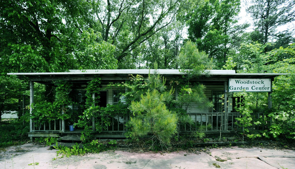 FILE - In this May 3, 2017, file photo is the remains of a business that was only open briefly in Woodstock, Ala., once operated with the help of John B. McLemore, who is featured in the serialized podcast "S-Town." A lawsuit against the makers of the hit podcast “S-Town” has been dismissed after a settlement with the late protagonist's estate. WIAT-TV reported Tuesday, May 19, 2020, that the suit filed by the estate of John B. McLemore was dismissed March 12. (AP Photo/Jay Reeves, File)