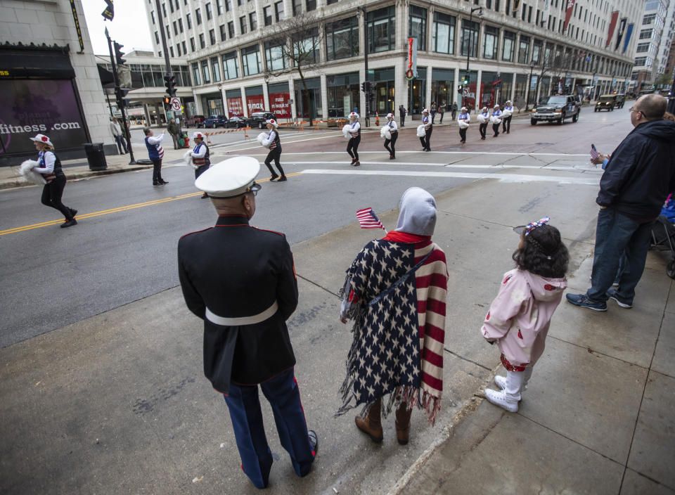 Parade-goers watch as members of the Milwaukee Dancing Grannies march by at a Veterans’ Day parade in Milwaukee on Saturday, Nov. 5, 2022. The Grannies, founded in 1984, are a crowd favorite in Wisconsin and have members ranging in age from mid-50s to 77. (AP Photo/Kenny Yoo)