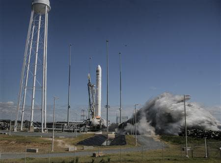 The Orbital Sciences Corporation Antares rocket, with the Cygnus cargo spacecraft aboard, launches from NASA's Wallops Flight Facility in Virginia in this handout photo taken September 18, 2013. The unmanned Antares rocket blasted off on Wednesday, sending a cargo capsule to the International Space Station. The rocket placed the Cygnus capsule, loaded with about 1,543 pounds (700 kg) of food, clothing and other supplies, into orbit about 170 miles (274 km) above Earth. REUTERS/Thom Baur/Orbital/Handout via Reuters