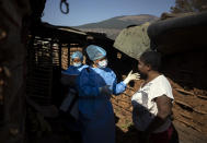 Nomautanda Siduna advises Pretty Mkhabela, a HIV-positive woman, how to stay as safe as possible amid the added threat of COVID-19 at a mobile clinic in Ngodwana, South Africa, Thursday, July 2, 2020. Across Africa and around the world, the COVID-19 pandemic has disrupted the supply of antiretroviral drugs to many of the more than 24 million people who take them, endangering their lives. An estimated 7.7 million people in South Africa are HIV positive, the largest number in the world, and 62% of them take the antiretroviral drugs that suppress the virus and prevent transmission. (AP Photo/Bram Janssen)