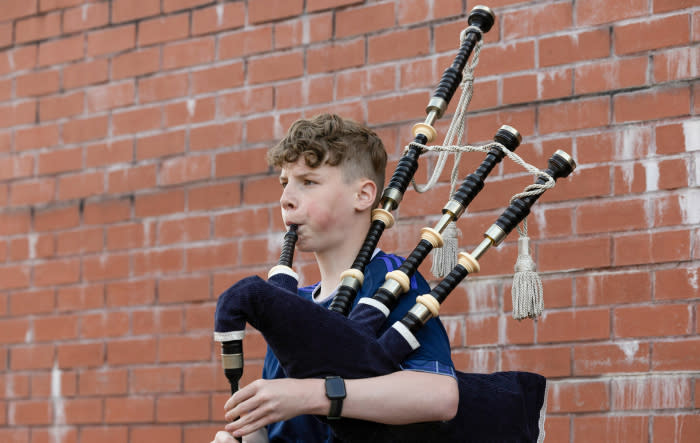GLASGOW, SCOTLAND - SEPTEMBER 12: A young Scotland fan plays the bagpipes during the 150th Anniversary Heritage Match between Scotland and England at Hampden Park, on September 12, 2023, in Glasgow, Scotland.  (Photo by Craig Foy / SNS Group)