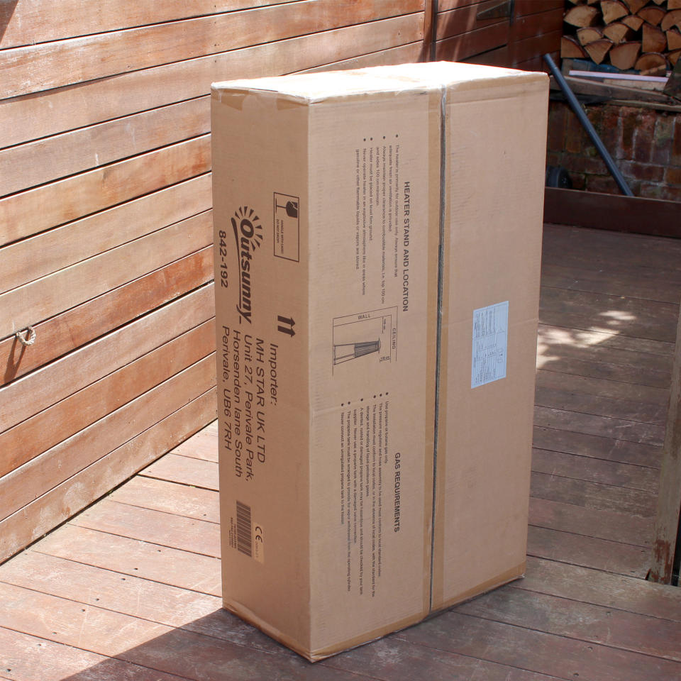 The Outsunny 11.2kw Pyramid Gas Patio Heater being unboxed and tested on a wooden deck