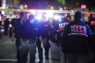 CORRECTS DAY AND DATE - New York City police officers work a scene early Thursday, June 4, 2020, in the Brooklyn borough of New York. The police department says a police officer has been shot in Brooklyn. The shooting happened late Wednesday, nearly four hours after an 8 p.m. curfew went into effect intended to quell unrest over the death of George Floyd in Minnesota. Details on the shooting, including the officer's condition, weren’t immediately available. (AP Photo/Frank Franklin II)