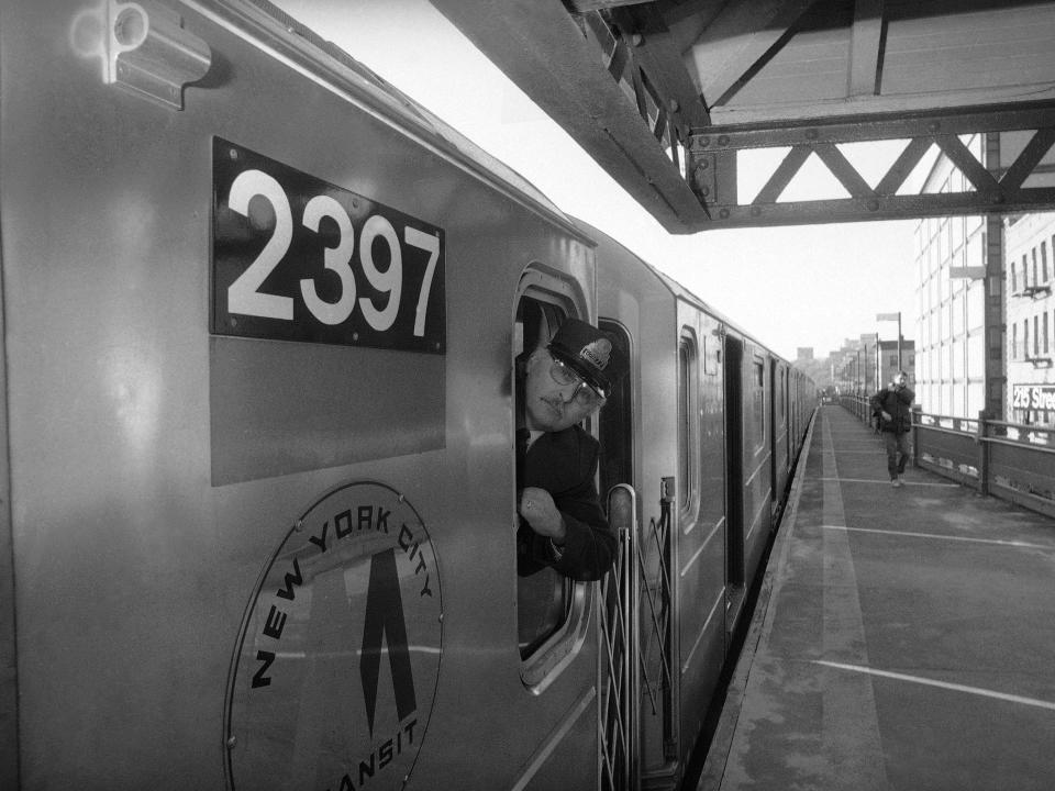 Subway conductor watches the platform and monitors of the closing doors at 231st St