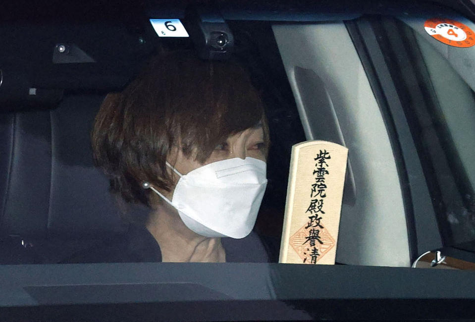 Akie Abe, wife of former Prime Minister Shinzo Abe, is seen in the hearse, as the hearse carrying Abe's body leaves Zojoji temple after his funeral in Tokyo on Tuesday, July 12, 2022. Abe was assassinated Friday while campaigning in Nara, western Japan.(Kyodo News via AP)