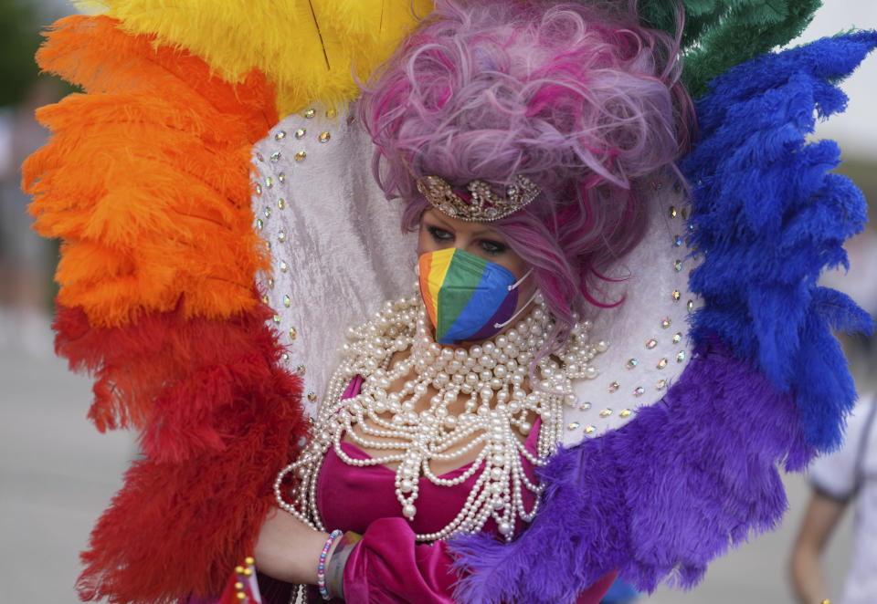 A football supporter wears a rainbow costume before the Euro 2020 soccer championship group F match between Germany and Hungary at the Allianz Arena in Munich, Germany,Wednesday, June 23, 2021. (AP Photo/Matthias Schrader)