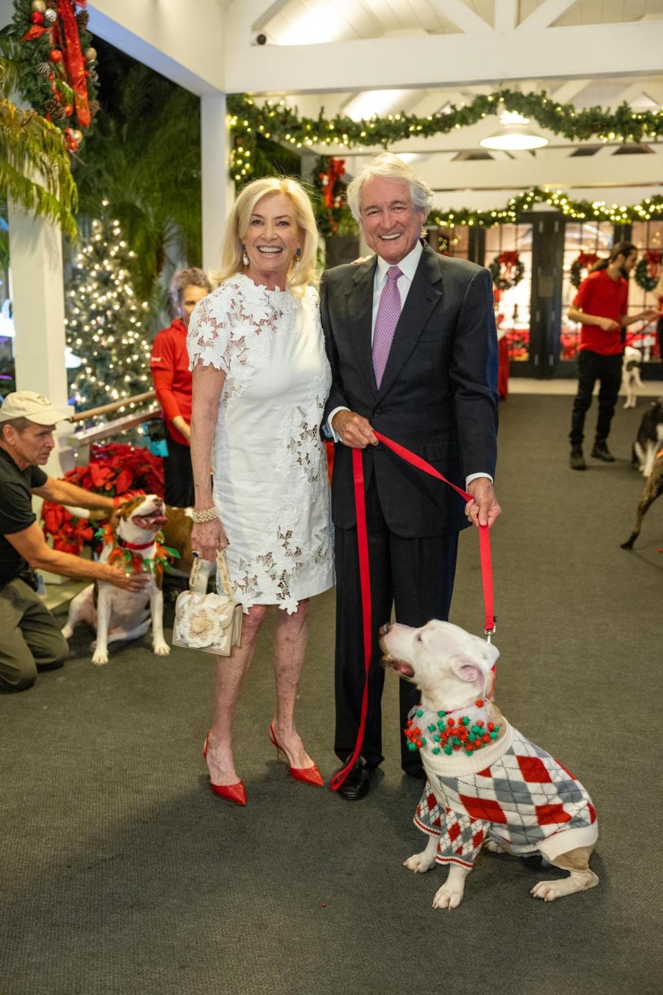 Pauline Pitt and Jerry Seay with an adoption hopeful at a recent Peggy Adams Animal Rescue League Christmas Ball. Pitt is the chairwoman of this year's ball, set for Dec. 8 at the Sailfish Club.