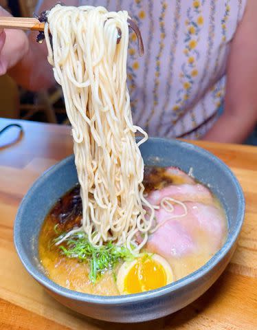 <p>Courtesy of Yelp</p> A customer enjoying a bowl of ramen from Youta Ramen in Mineola, New York