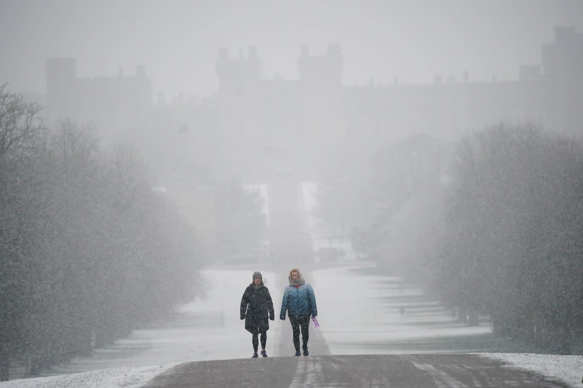 Snow settles along the Long Walk towards Windsor Castle after the UK’s coldest night of the year (PA Wire)