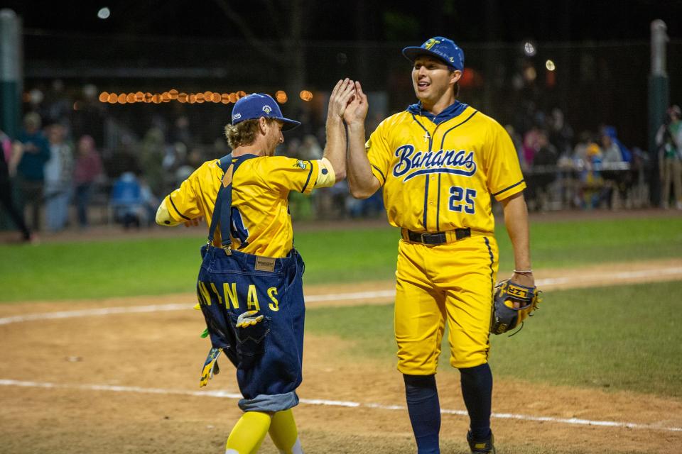 The Savannah Bananas Premier Team's Mat Wolf (4)  and Christian Dearman (25) celebrate after a big out of the Banana Ball game against the Party Animals on Saturday, March 12, 2022, at Grayson Stadium.