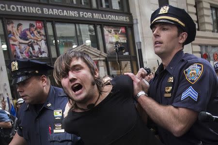New York City police officers arrest a man taking part in the Flood Wall Street demonstration in Lower Manhattan, New York September 22, 2014. REUTERS/Adrees Latif