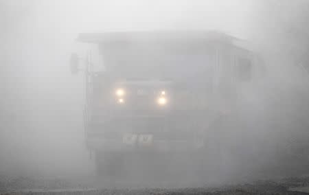 A truck drives through copper ore dust from the mining pit at the Bisha Mining Share Company (BMSC) in Eritrea, operated by Canadian company Nevsun Resources, February 18, 2016 REUTERS/Thomas Mukoya/File Photo