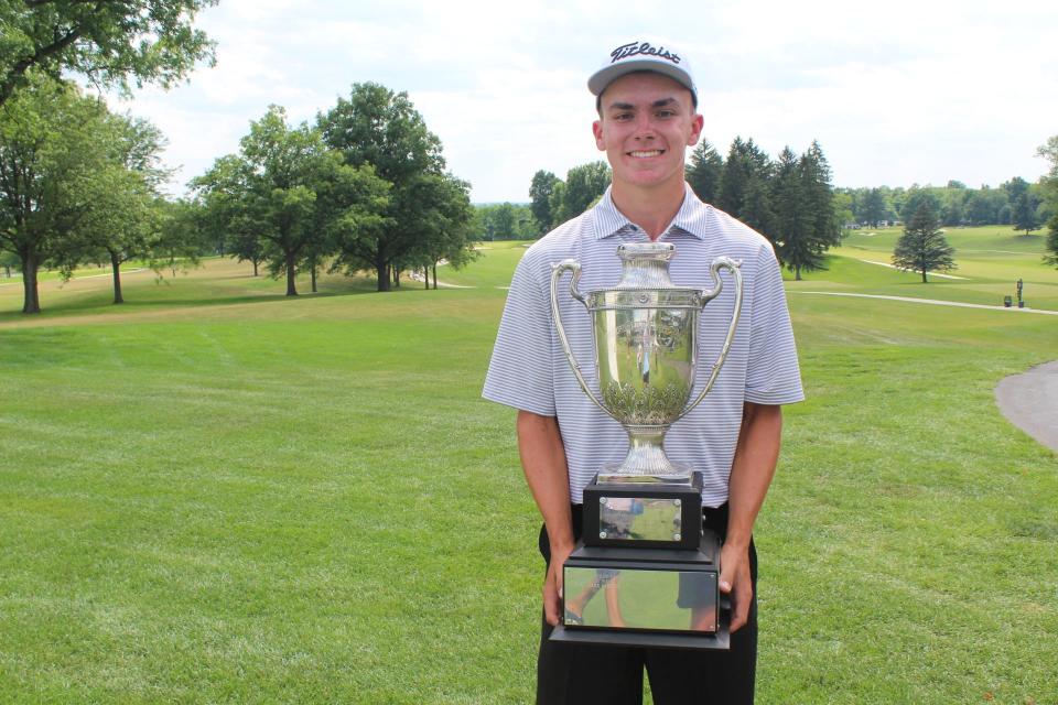 Kent State's Jordan Gilkison holds his championship trophy after winning the 101st Ohio Open.