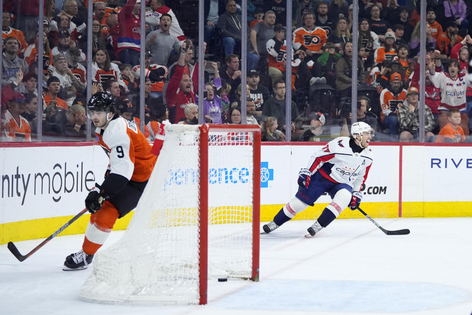 Washington Capitals' T.J. Oshie, right, celebrates after scoring a goal against Philadelphia Flyers' Jamie Drysdale during the third second period of an NHL hockey game, Tuesday, April 16, 2024, in Philadelphia. (AP Photo/Matt Slocum)