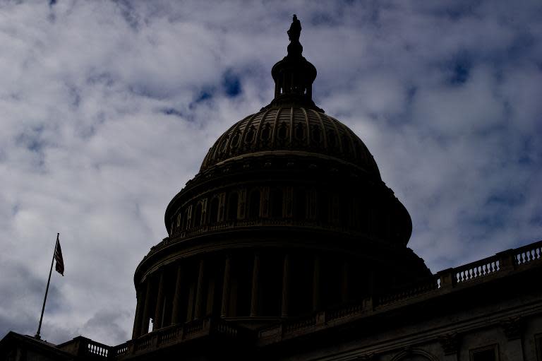 The US Capitol is silhouetted on September 28, 2013 in Washington