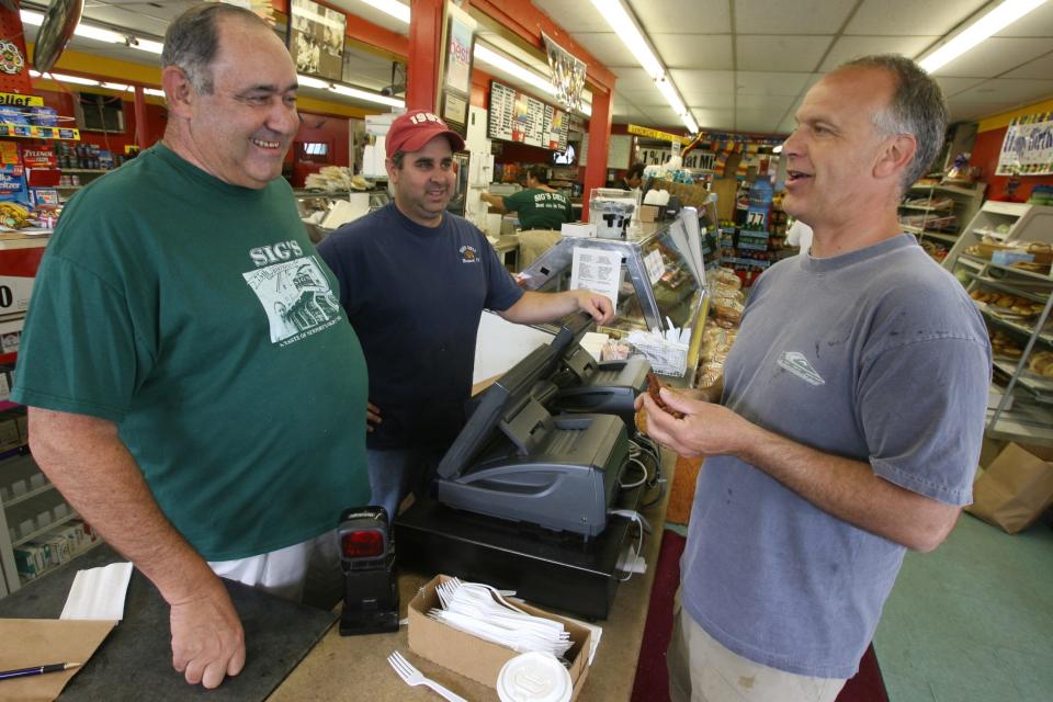 Shawn Margolis, center, stands next to his late father, Morris Margolis, and chats with customer Peter Kane inside the old Sig's Market and Deli in Newport in 2007. Shawn Margolis opened Sig's Place Deli and Catering in 2010 in Middletown.