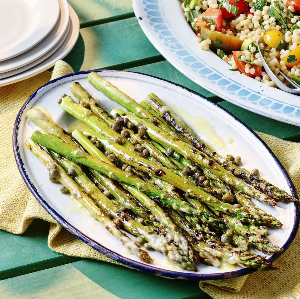 <p>A fragrant and fresh BBQ side dish. This asparagus with lemon and caper butter is an easy summer dish perfect for BBQs and alfresco dining.</p><p><strong>Recipe: <a href="https://www.goodhousekeeping.com/uk/food/recipes/a36828479/asparagus-lemon-caper-butter/" rel="nofollow noopener" target="_blank" data-ylk="slk:Asparagus with Lemon and Caper Butter;elm:context_link;itc:0;sec:content-canvas" class="link ">Asparagus with Lemon and Caper Butter</a></strong></p>