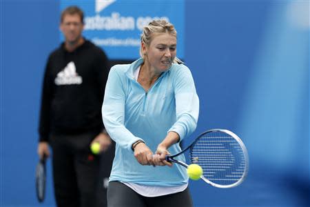 Maria Sharapova of Russia hits a return during a practice session at the Australian Open 2014 tennis tournament in Melbourne January 12, 2014. REUTERS/Bobby Yip