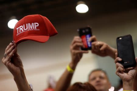 People wave hats and hold phones as Republican presidential nominee Donald Trump holds a rally with supporters in Aston, Pennsylvania, U.S. September 22, 2016. REUTERS/Jonathan Ernst