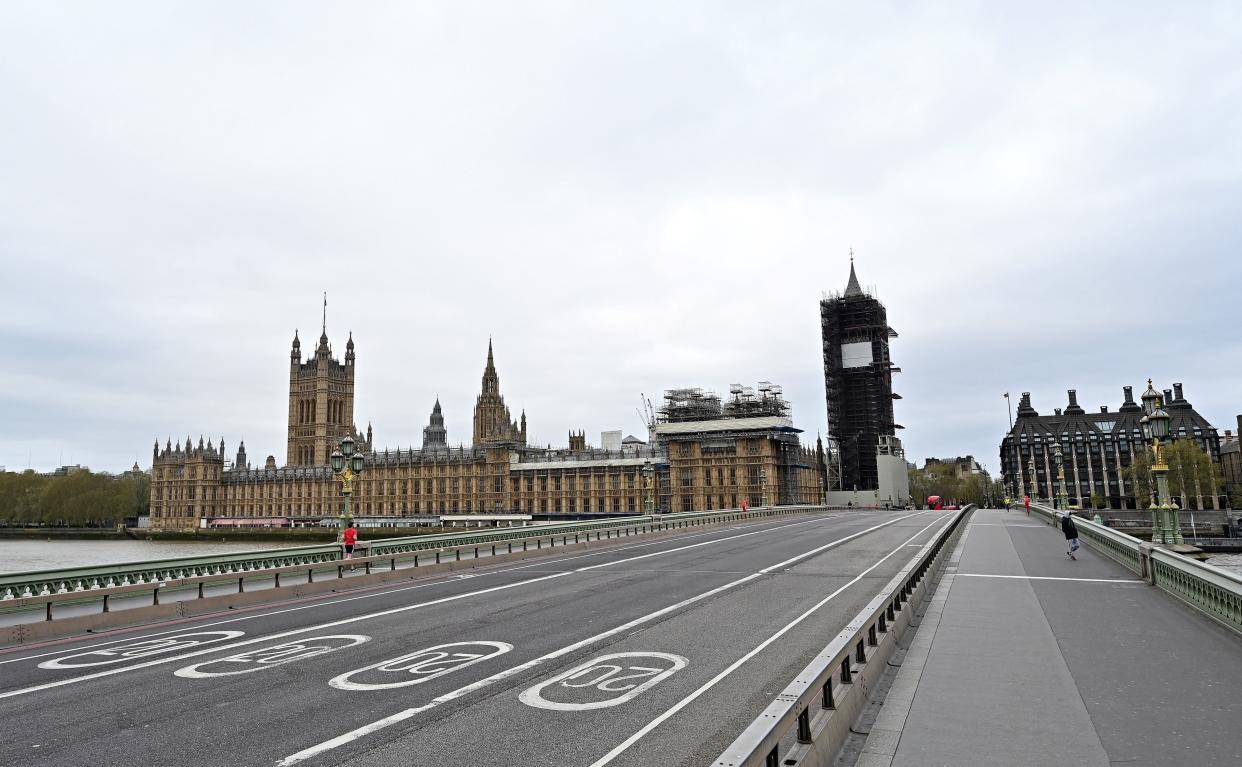 An empty Westminster Bridge is pictured in front of Britain's Houses of Parliament in central London on April 13, 2020, as life in Britain continues over the Easter weekend, during the nationwide lockdown to combat the novel coronavirus pandemic. - Virus-stricken British Prime Minister Boris Johnson thanked medics for saving his life after leaving hospital on Easter Sunday, as hundreds of millions of Christians observed the holiday under lockdown due to the coronavirus pandemic. More than half of humanity is confined at home as governments scramble to stop the COVID-19 pandemic, which has claimed more than 112,500 lives around the world. (Photo by Glyn KIRK / AFP) (Photo by GLYN KIRK/AFP via Getty Images)