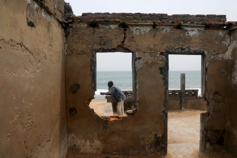 Adjahi Komlan, a grandson of former Chief of Afidegnigban Mr Koukou Denis Apedo, looks out to sea in Afidegnigban