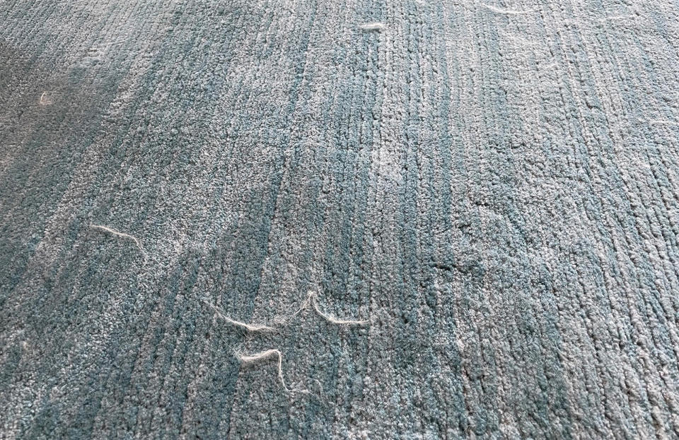 A carpet covered with balled-up dog hair after the Roomba j7+ finished cleaning. - Credit: Maren Estrada for BGR