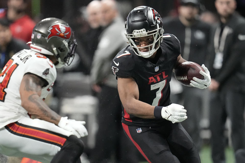 Atlanta Falcons running back Bijan Robinson (7) prepares to take on Tampa Bay Buccaneers safety Antoine Winfield Jr. (31) on a long run during the second half of an NFL football game, Sunday, Dec. 10, 2023, in Atlanta. (AP Photo/Mike Stewart)