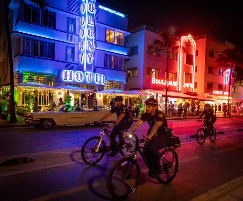 Miami Beach police officers patrol Ocean Drive on their bicycles on Feb. 29, 2024.