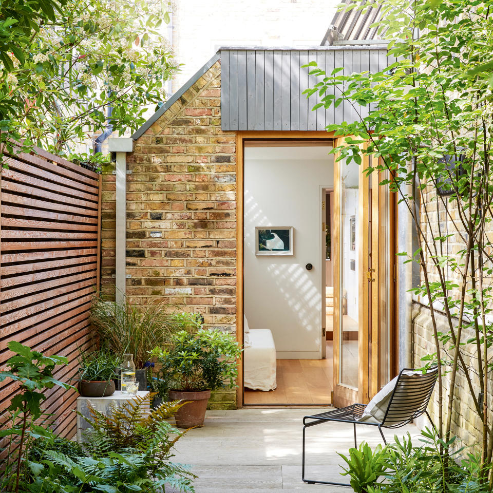 Narrow courtyard garden with potted plants