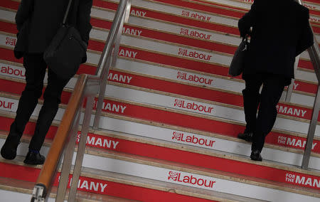 Attendees walk up a branded staircase at the Labour Party Conference venue in Brighton, Britain, September 26, 2017. REUTERS/Toby Melville