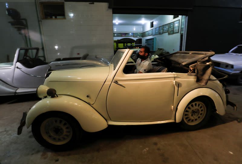 Ayman Sima, the 38-years-old son of Sayed Sima, an Egyptian collector of vintage cars, drives a British Standard Flying Eight Tourer - 1948 automobile at his father's store where he also has an exhibition of old cars, in the Giza suburb of Abu Rawash