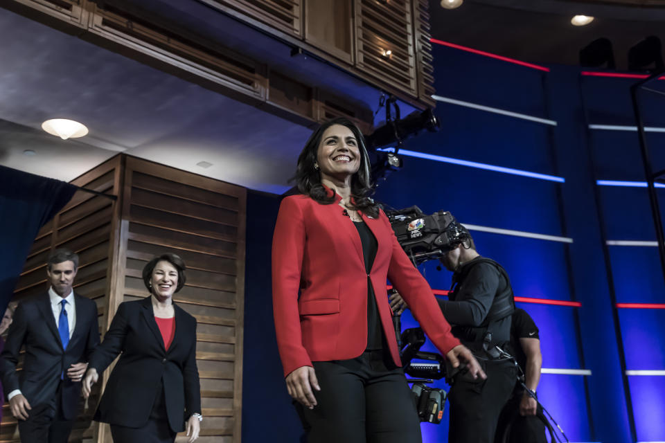 Presidential hopefuls (L-R) Former Texas Rep. Beto O’Rourke, Minnesota Sen. Amy Klobuchar and Hawaii Rep. Tulsi Gabbard arrive onstage for the first night of the Democratic presidential debate on June 26, 2019 in Miami, Florida. | Christopher Morris for TIME