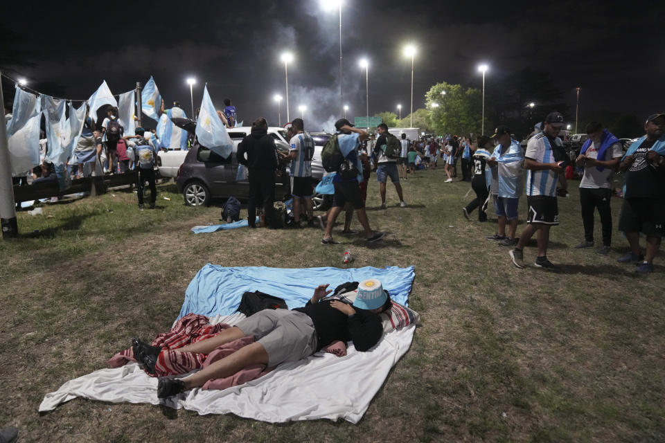 Fans waits for the arrival of the Argentine soccer team that won the World Cup outside the AFA training grounds in Buenos Aires, Argentina, Tuesday, Dec. 20, 2022. (AP Photo/Matilde Campodonico)