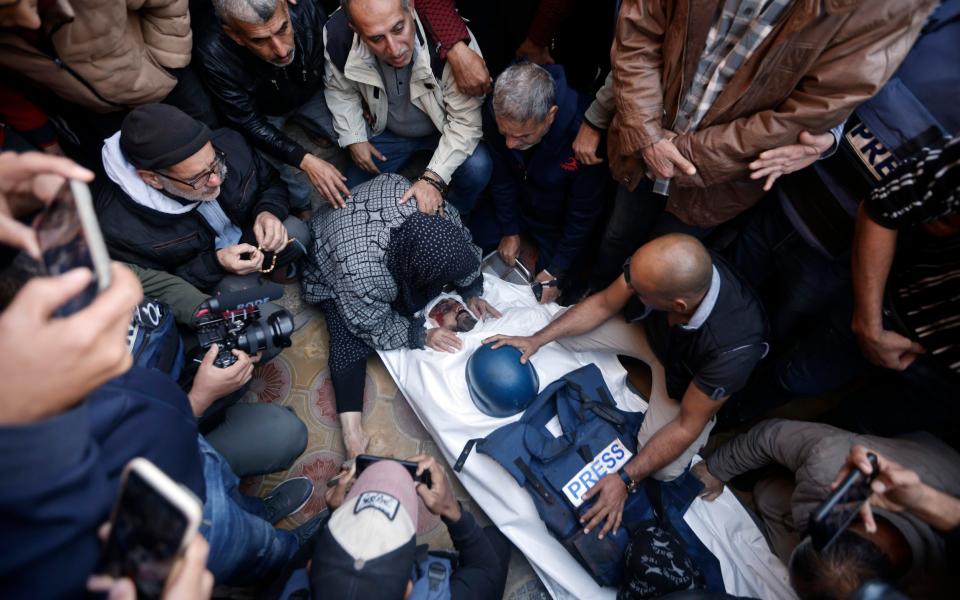 Relatives of Samer Abu Daqqa mourn over his body