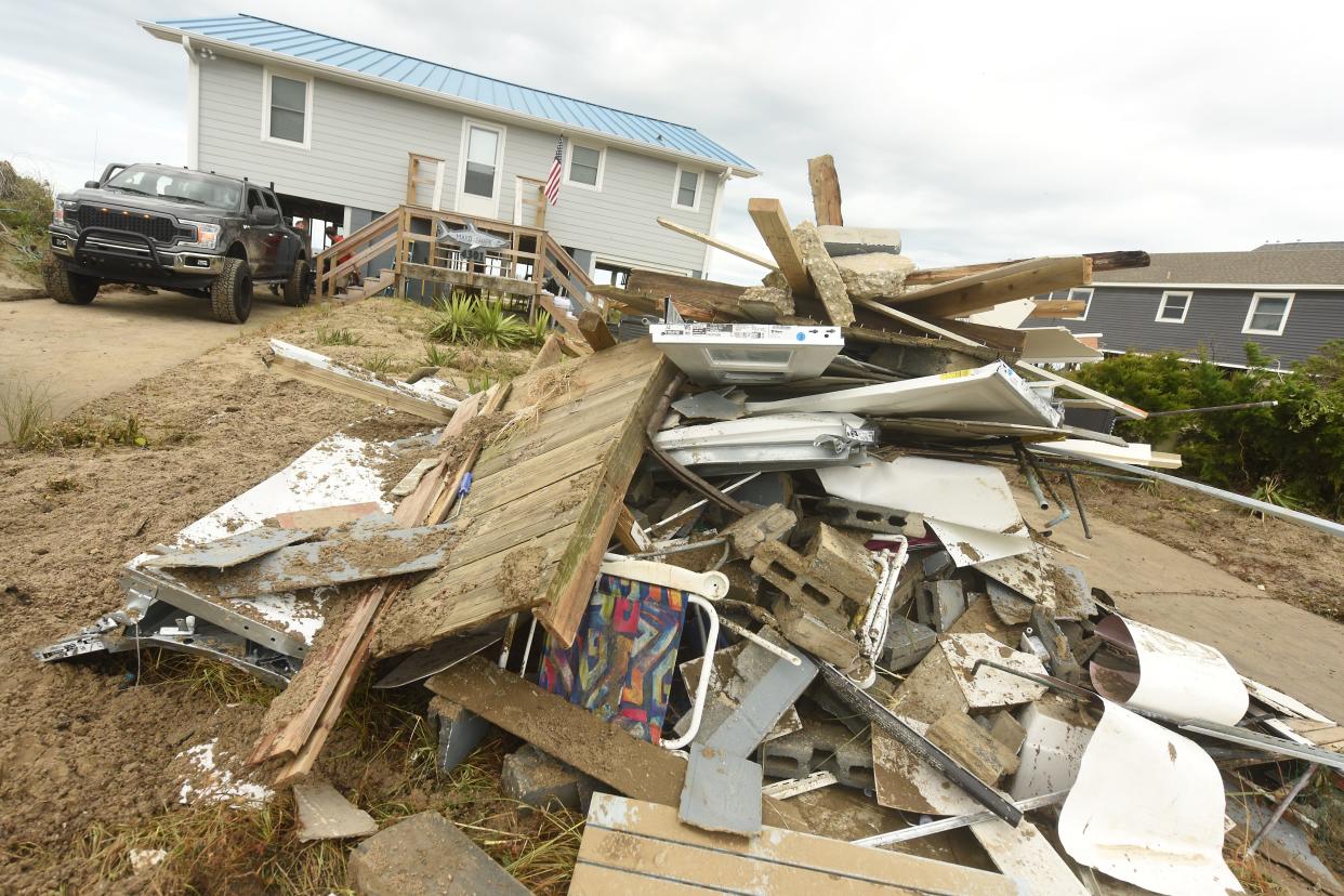 Crews and residents continue to clean up Wednesday Aug. 5, 2020 along Oak Island, N.C. after Hurricane Isaias. Isaias came ashore Monday night in Brunswick County as a category 1 hurricane.